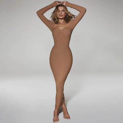 Person wearing a brown bodysuit against a plain background