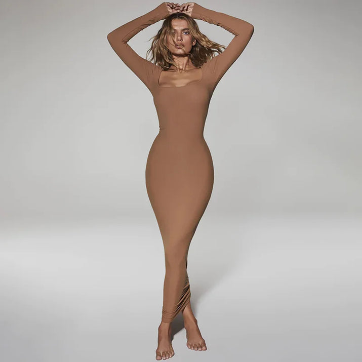 Person wearing a brown bodysuit against a plain background